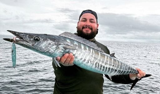Happy angler holding a large wahoo caught near Caño Island, Costa Rica
